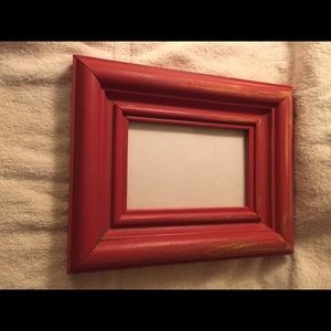 Antiqued finished wood dark red picture frame.